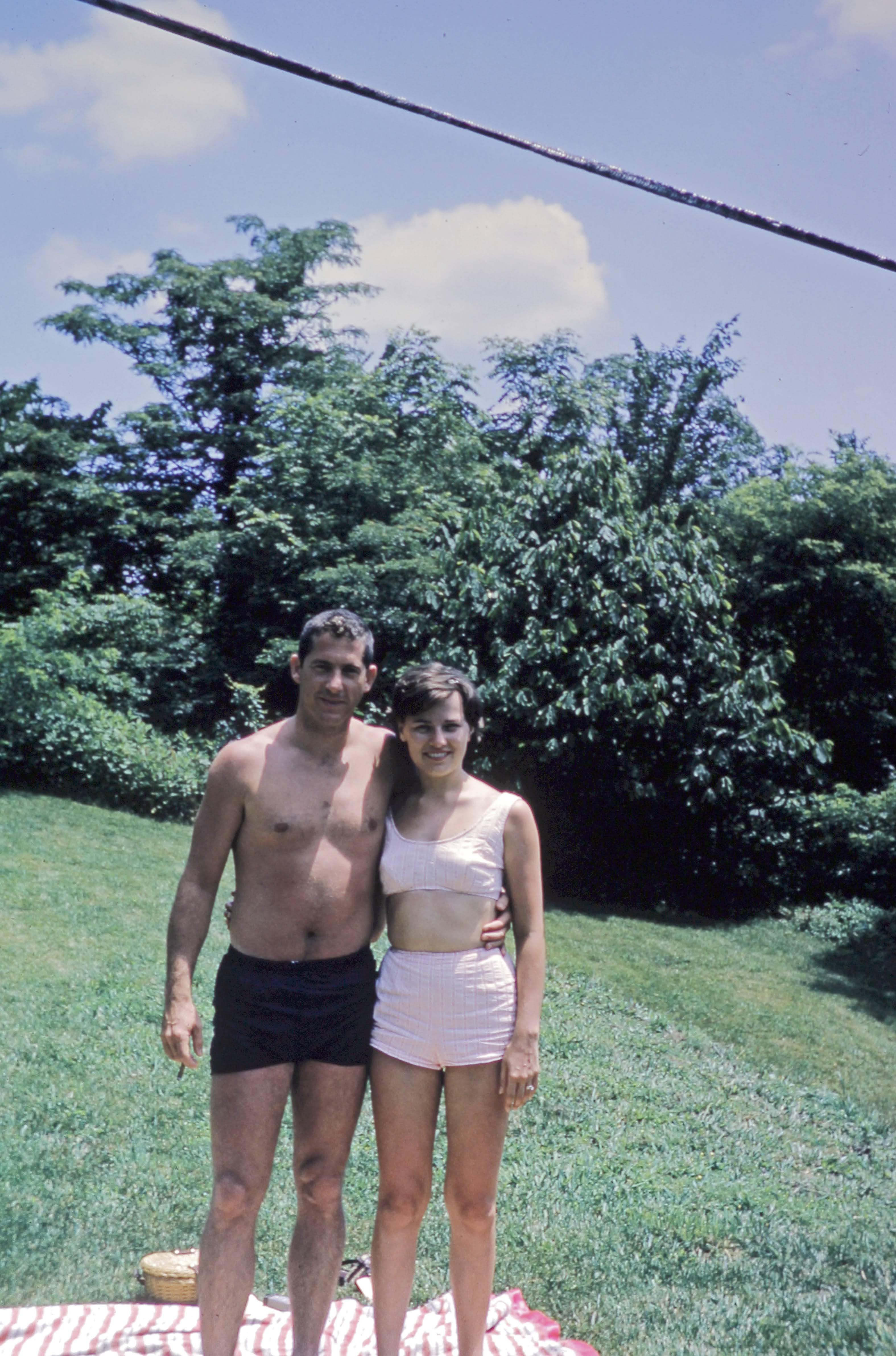 Don and Joy McCool standing together in a sunny backyard.